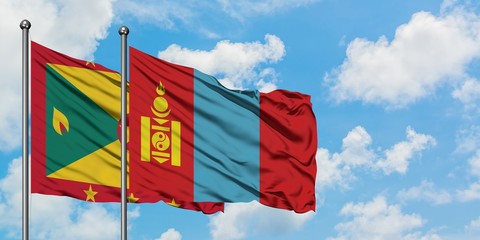 Grenada and Mongolia flag waving in the wind against white cloudy blue sky together. Diplomacy concept, international relations.