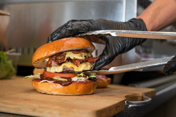 Preparation of burger. Street food. Professional chef is preparing burger