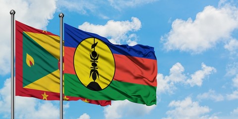 Grenada and New Caledonia flag waving in the wind against white cloudy blue sky together. Diplomacy concept, international relations.
