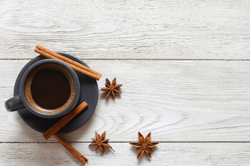 Grey cup of coffee and spices on wooden white table. Hot drink concept. Coffee shop, espresso, spice, shot, object