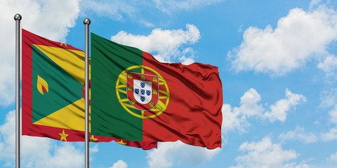 Grenada and Portugal flag waving in the wind against white cloudy blue sky together. Diplomacy concept, international relations.