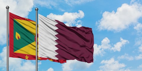 Grenada and Qatar flag waving in the wind against white cloudy blue sky together. Diplomacy concept, international relations.