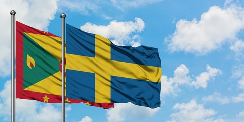Grenada and Sweden flag waving in the wind against white cloudy blue sky together. Diplomacy concept, international relations.