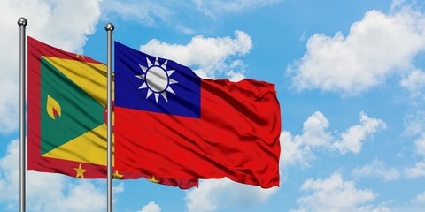 Grenada and Taiwan flag waving in the wind against white cloudy blue sky together. Diplomacy concept, international relations.