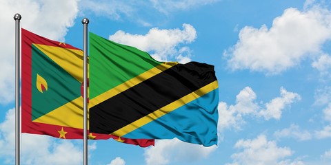 Grenada and Tanzania flag waving in the wind against white cloudy blue sky together. Diplomacy concept, international relations.