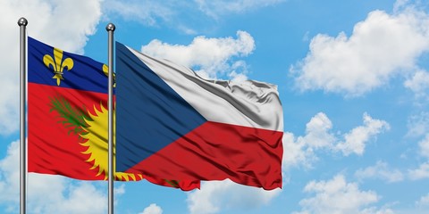 Guadeloupe and Czech Republic flag waving in the wind against white cloudy blue sky together. Diplomacy concept, international relations.