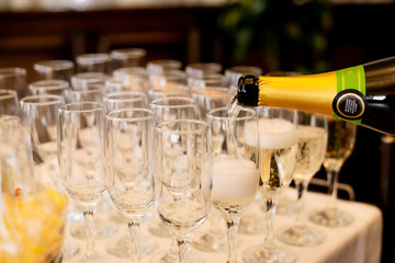 glass of beer and bottle of wine on table
