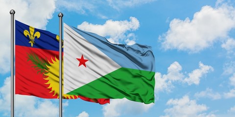 Guadeloupe and Djibouti flag waving in the wind against white cloudy blue sky together. Diplomacy concept, international relations.