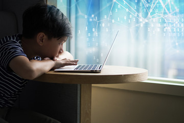 A young and smart looking Asian teen boy watch online lessons, study programming and coding, researching projects with laptop computer. E-Learning, Digital Technology in Education concept.