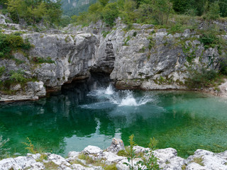 Vicenza, ITALY - AUGUST 13, 2019: mountain river near the village of Localita Pria. people jump from a cliff into the water