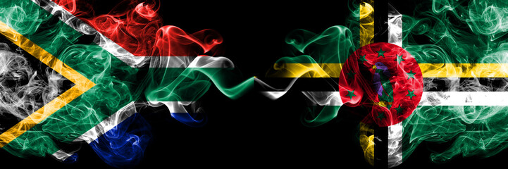 South Africa vs Dominica smoky mystic flags placed side by side. Thick colored silky abstract smoke...