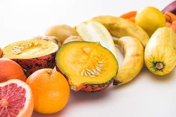 Fototapeta na wymiar oranges, pumpkin, bananas, zucchini, lemon on white background