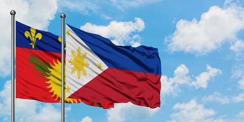 Guadeloupe and Philippines flag waving in the wind against white cloudy blue sky together. Diplomacy concept, international relations.