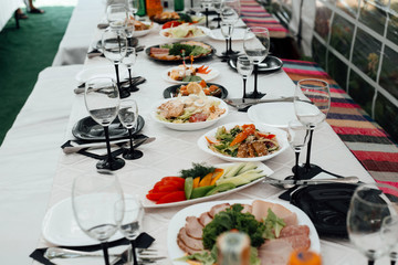 A lot of various meal on a banquet table. Festively served table at restaurant for a banquet. The party - on a table a lot of various meal is necessary.