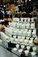 Candy Bar. Birthday table decoration. Candy bar for party. Dessert table for a party. Cake, cupcakes, sweetness. Elegant and luxurious event arrangement.  Luxury life. Delicious sweets on candy buffet