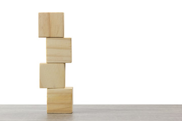 stack of wooden block on wood table against white background.