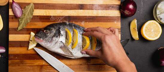 girl cooks dorado fish