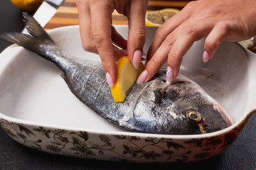 girl cooks dorado fish
