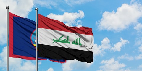 Guam and Iraq flag waving in the wind against white cloudy blue sky together. Diplomacy concept, international relations.