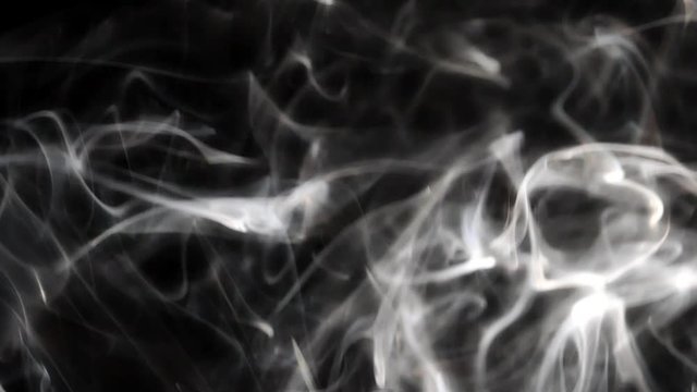 Beautiful smoke on a black background. Smoky texture. Steam rises.