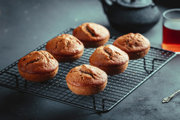 Homemade fresh banana and chocolate muffins on cooling rack.