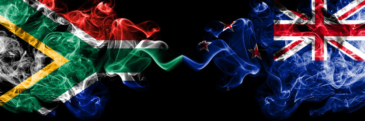 South Africa vs New Zealand, New Zealander smoky mystic flags placed side by side. Thick colored silky abstract smoke flags concept