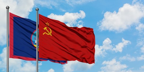 Guam and Soviet Union flag waving in the wind against white cloudy blue sky together. Diplomacy concept, international relations.