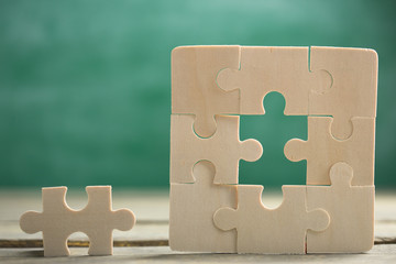 Creative solution for idea - business concept, jigsaw puzzle on the blackboard