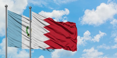 Guatemala and Bahrain flag waving in the wind against white cloudy blue sky together. Diplomacy concept, international relations.