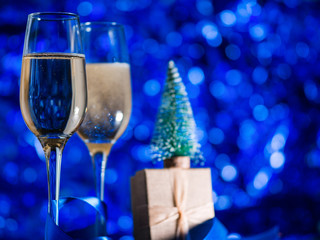 Happy new year and merry Christmas 2020. Two glasses of champagne on a holiday blue background