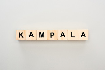 top view of wooden blocks with Kampala lettering on grey background