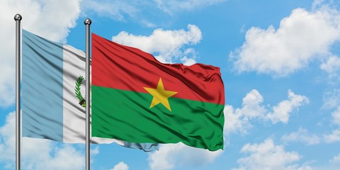 Guatemala and Burkina Faso flag waving in the wind against white cloudy blue sky together. Diplomacy concept, international relations.