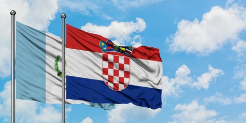 Guatemala and Croatia flag waving in the wind against white cloudy blue sky together. Diplomacy concept, international relations.