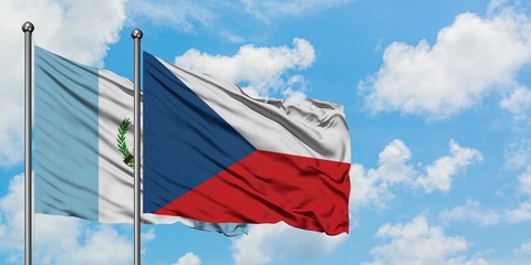 Guatemala and Czech Republic flag waving in the wind against white cloudy blue sky together. Diplomacy concept, international relations.