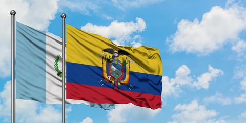 Guatemala and Ecuador flag waving in the wind against white cloudy blue sky together. Diplomacy concept, international relations.