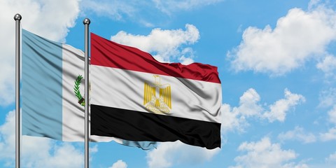 Guatemala and Egypt flag waving in the wind against white cloudy blue sky together. Diplomacy concept, international relations.