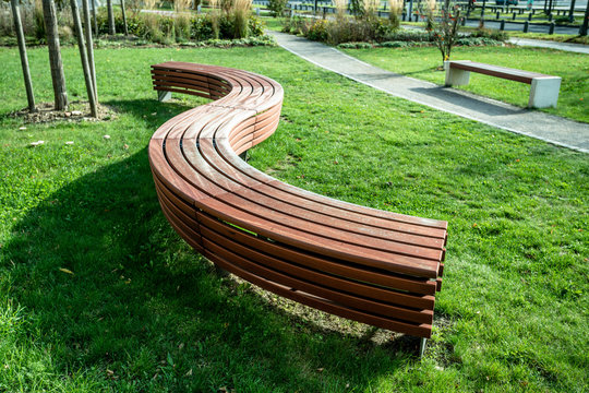 A modern bench  in a city park on a sunny day