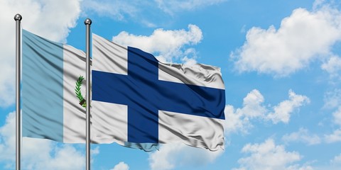 Guatemala and Finland flag waving in the wind against white cloudy blue sky together. Diplomacy concept, international relations.