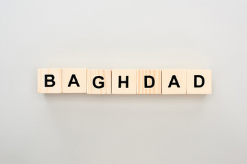 top view of wooden blocks with Baghdad lettering on grey background