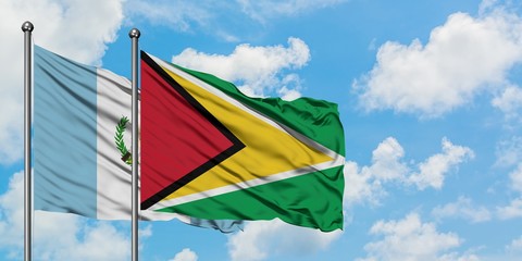 Guatemala and Guyana flag waving in the wind against white cloudy blue sky together. Diplomacy concept, international relations.
