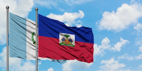 Guatemala and Haiti flag waving in the wind against white cloudy blue sky together. Diplomacy concept, international relations.