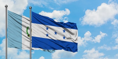 Guatemala and Honduras flag waving in the wind against white cloudy blue sky together. Diplomacy concept, international relations.