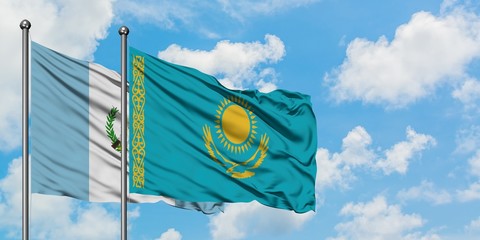 Guatemala and Kazakhstan flag waving in the wind against white cloudy blue sky together. Diplomacy concept, international relations.