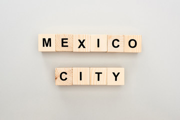top view of wooden blocks with Mexico City lettering on grey background
