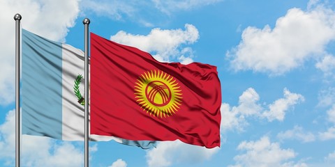 Guatemala and Kyrgyzstan flag waving in the wind against white cloudy blue sky together. Diplomacy concept, international relations.
