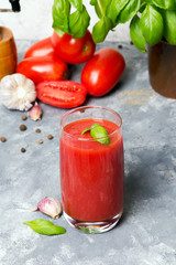 Tasty tomato juice with fresh spices, garlic, pepper and basil