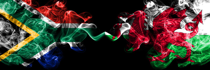 South Africa vs Wales, Welsh smoky mystic flags placed side by side. Thick colored silky abstract smoke flags concept