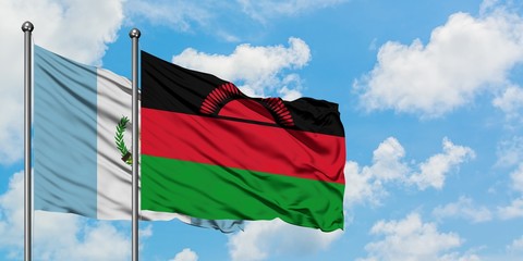Guatemala and Malawi flag waving in the wind against white cloudy blue sky together. Diplomacy concept, international relations.