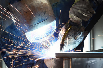 welder works in metal construction - construction and processing of steel components