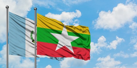 Guatemala and Myanmar flag waving in the wind against white cloudy blue sky together. Diplomacy concept, international relations.